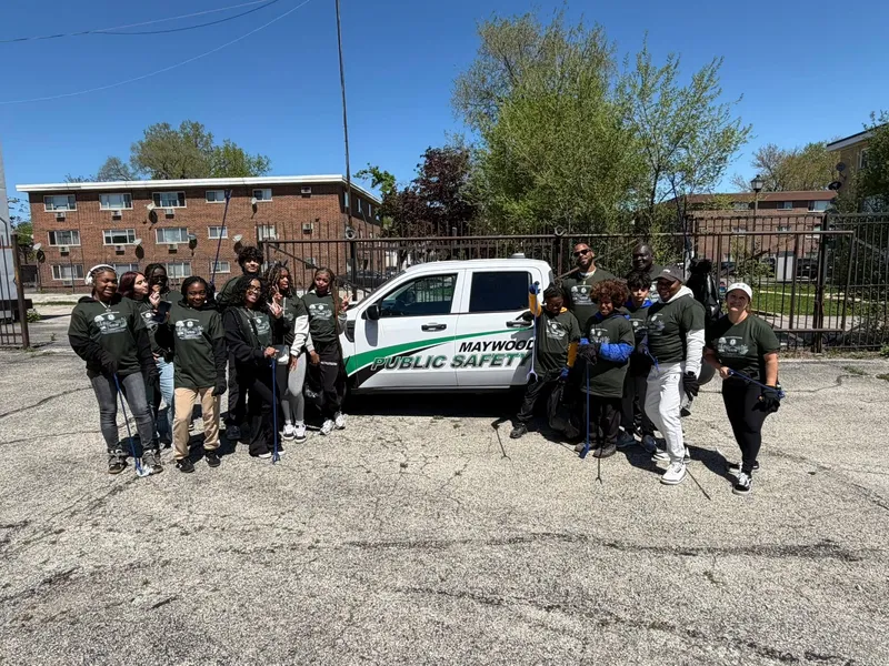 Volunteers gathered beside a Maywood Public Safety vehicle