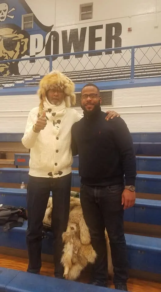 Miguel Jones with Mr. Mobley in a school gym